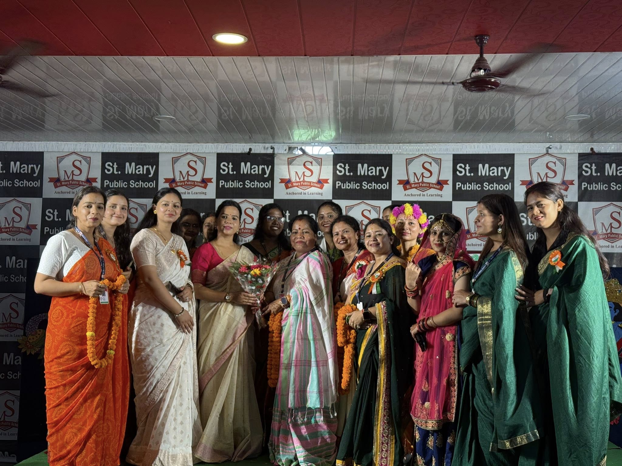 Teachers in traditional attire celebrating Teacher's Day on stage