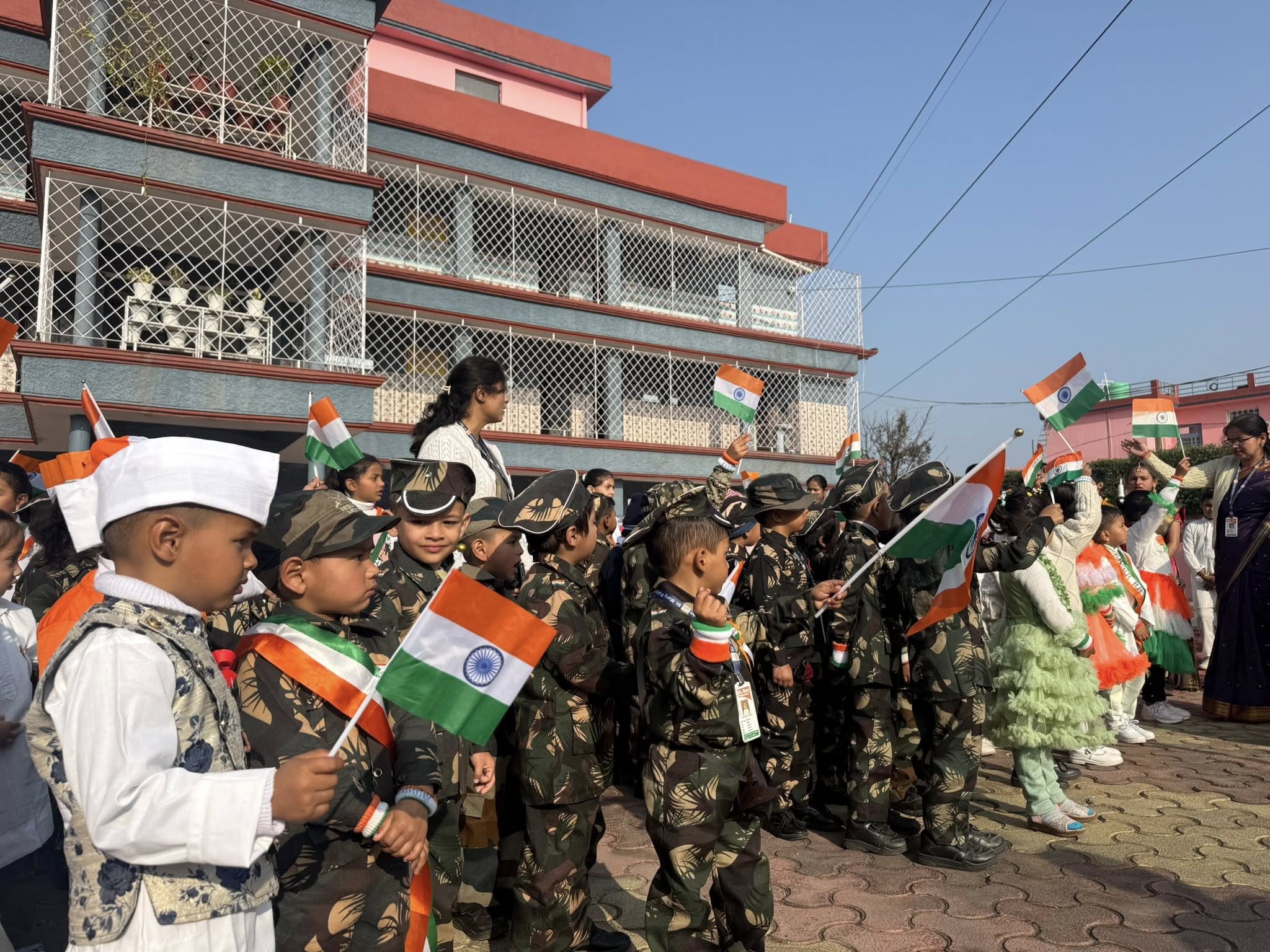 Students waving Indian flags dressed in army uniforms on Republic Day