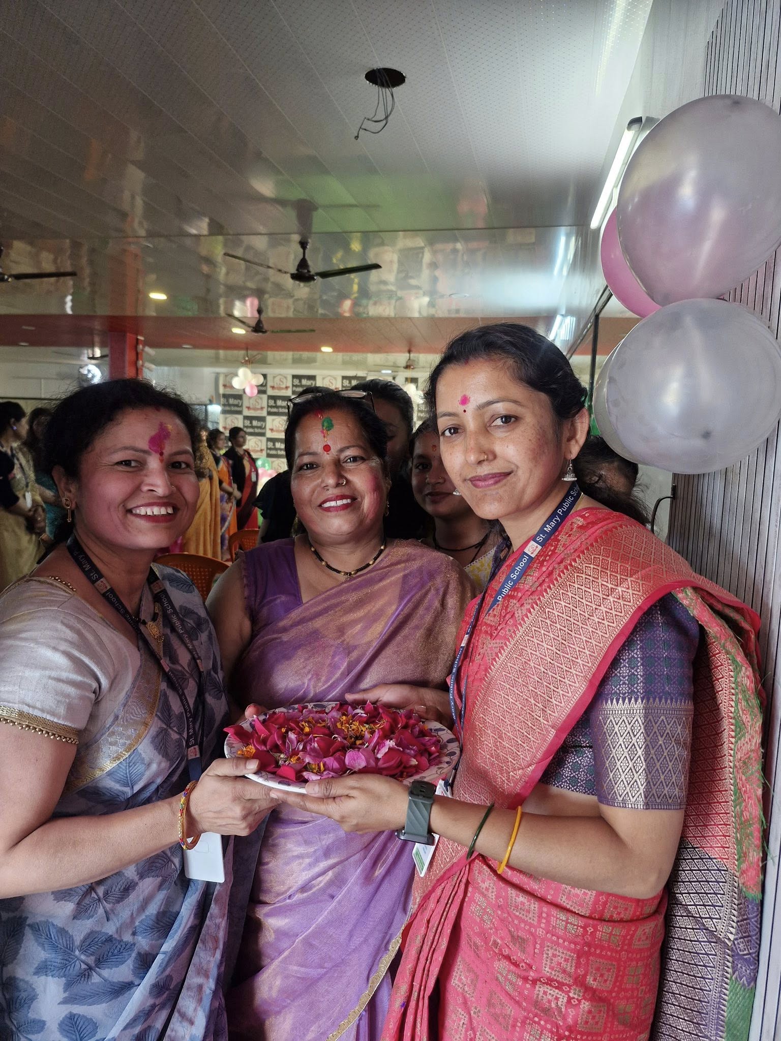 Teachers celebrating Holi with flower petals and smiles