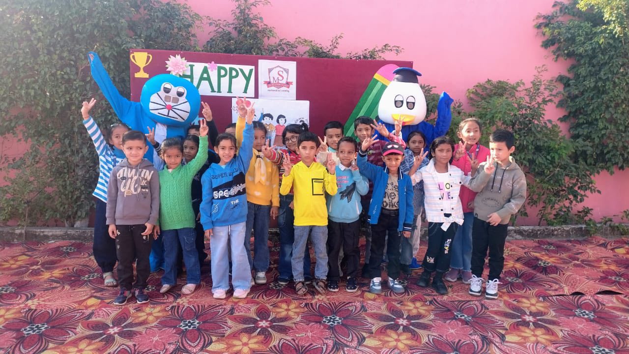 Students joyfully posing with Doraemon mascot on a special school day